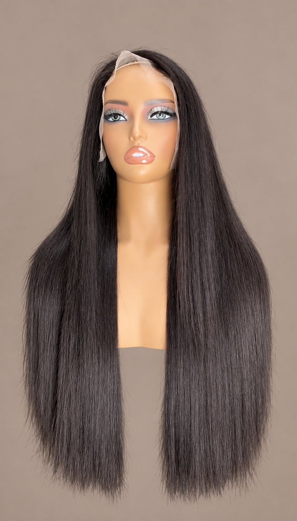 Long straight wig on a mannequin against a warm taupe background